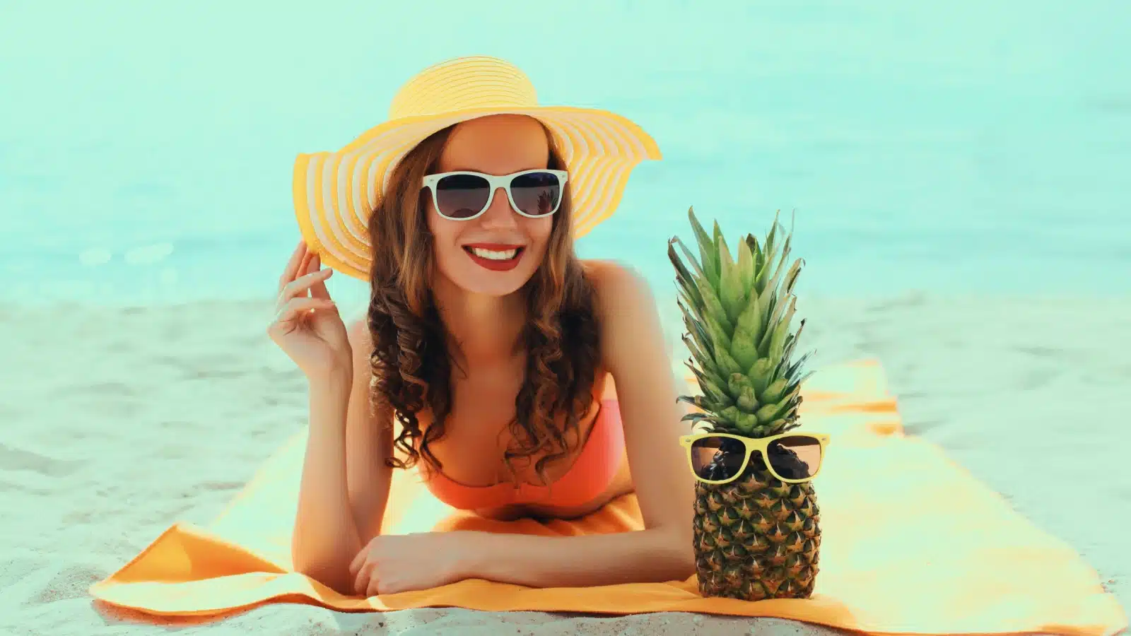 A woman lays on the beach to represent the best summer activities.