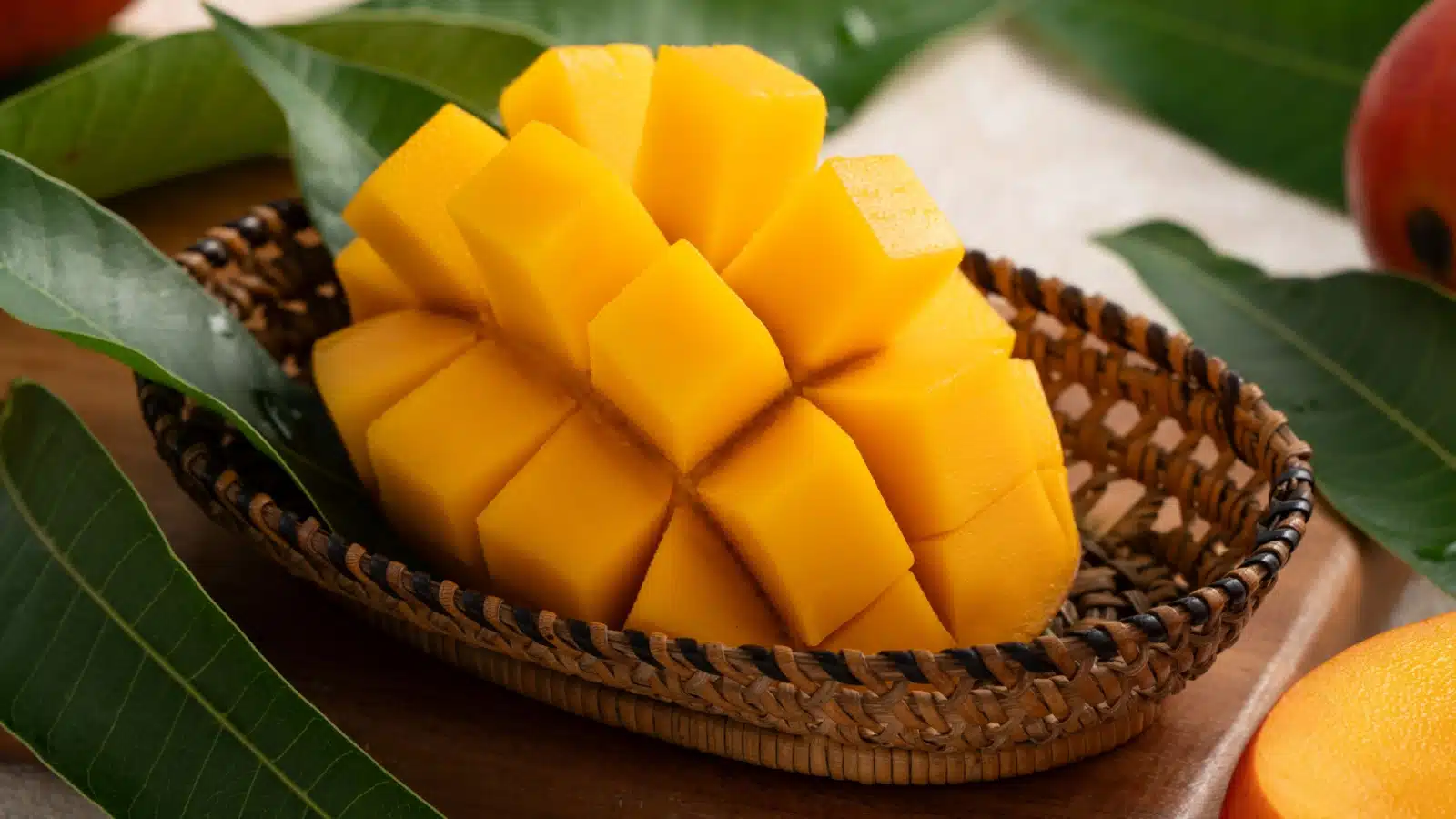 Sliced mango in a wooden basket.