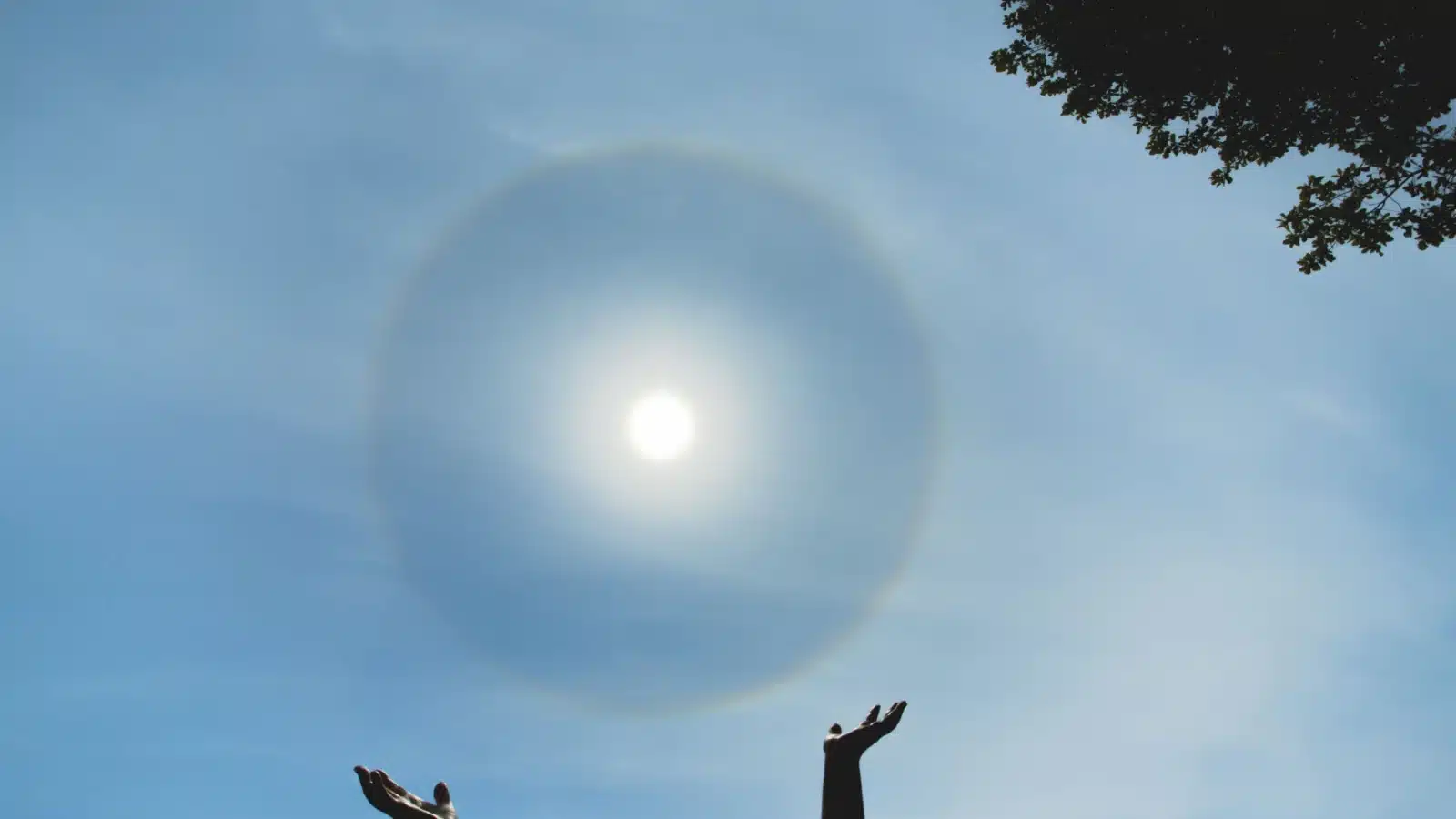 Hands reaching up toward the sun represent the biggest summer holiday: the summer solstice.