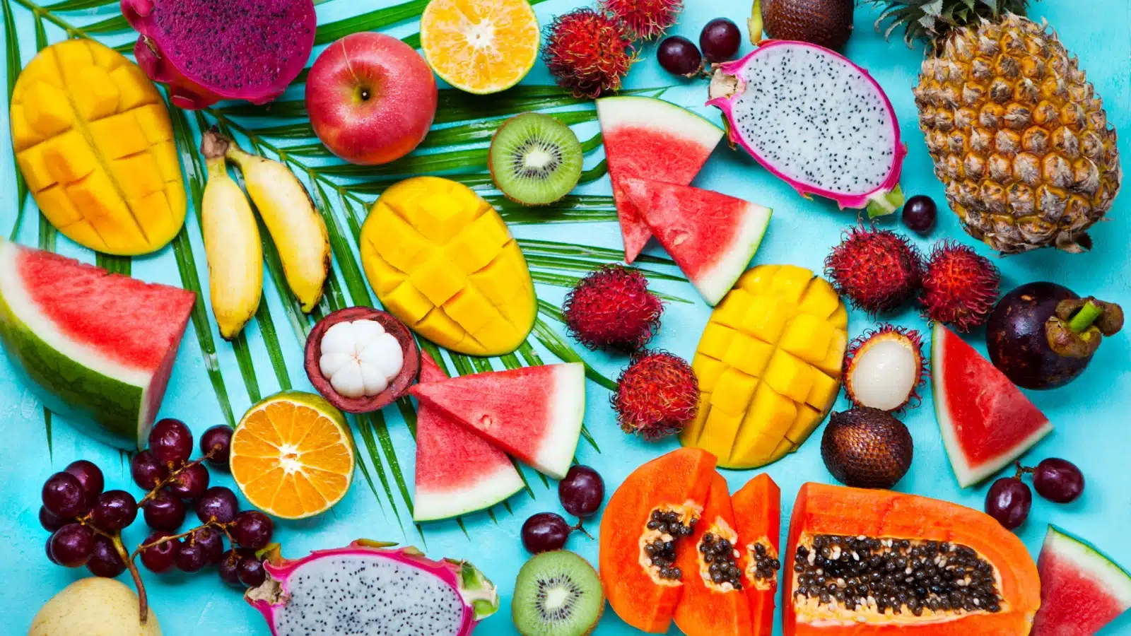 Assortment of tropical fruit on a blue background.